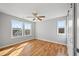 Spacious bedroom with hardwood floors, a ceiling fan, and natural light from multiple windows at 3205 Tackett Rd, Douglasville, GA 30135