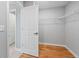 Bright walk-in closet features hardwood floors, wire shelving and neutral paint to easily showcase wardrobes at 3205 Tackett Rd, Douglasville, GA 30135