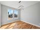 Well-lit dining room with hardwood floors, contemporary chandelier, and large windows at 3205 Tackett Rd, Douglasville, GA 30135