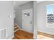 Bright foyer featuring hardwood floors, light gray walls, and a staircase leading to the upper level at 3205 Tackett Rd, Douglasville, GA 30135