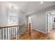 Bright hallway features hardwood floors, white trim, and a decorative light fixture, creating a welcoming transition space at 3205 Tackett Rd, Douglasville, GA 30135