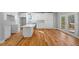 Kitchen featuring modern white cabinetry and countertop, stainless steel sink, hardwood flooring, and deck access at 3205 Tackett Rd, Douglasville, GA 30135