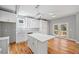 Bright kitchen boasts modern white cabinetry, stainless steel sink, and hardwood floors, with outside deck access at 3205 Tackett Rd, Douglasville, GA 30135