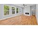 Bright living room boasts hardwood floors, recessed lights, a fireplace, and natural light from the surrounding greenery at 3205 Tackett Rd, Douglasville, GA 30135