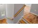 Wooden staircase showcasing hardwood steps and a light wood handrail in a neutrally decorated home at 3205 Tackett Rd, Douglasville, GA 30135