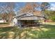 Side view of home with wooden porch and gray siding in a large green yard at 434 Mac Johnson Nw Rd, Cartersville, GA 30121