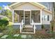 Inviting front porch with flower pots and weathered stairs leading up to a screen door entry at 434 Mac Johnson Nw Rd, Cartersville, GA 30121