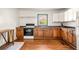 Traditional kitchen with wood cabinets, white appliances, and hardwood floors at 434 Mac Johnson Nw Rd, Cartersville, GA 30121