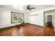 Open-concept living room featuring white walls, hardwood floors, and large bright windows at 434 Mac Johnson Nw Rd, Cartersville, GA 30121
