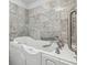 Close up on bathroom's marble-tiled walls and accessible safety walk-in bathtub at 4430 Tilly Mill Rd # 1304, Atlanta, GA 30360
