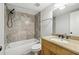 Updated bathroom features a shower and bath with decorative wall tiles, a granite vanity and hardware at 4430 Tilly Mill Rd # 1304, Atlanta, GA 30360