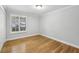 A clean and bright bedroom has a window to let in natural light and hardwood floors at 4430 Tilly Mill Rd # 1304, Atlanta, GA 30360