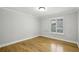 This bedroom features a window allowing for natural light and gleaming hardwood floors at 4430 Tilly Mill Rd # 1304, Atlanta, GA 30360