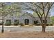 Commercial building featuring a gray exterior, arched entryway, and landscaping in a vibrant business district at 4430 Tilly Mill Rd # 1304, Atlanta, GA 30360