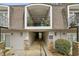 Condo building exterior featuring multiple levels, walkways, stone accents and lush landscaping at 4430 Tilly Mill Rd # 1304, Atlanta, GA 30360