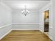 Dining room featuring hardwood floors, decorative chandelier, and neutral wall paint at 4430 Tilly Mill Rd # 1304, Atlanta, GA 30360