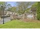 Stone condominium entrance at Chateau Dunwoody featuring manicured lawns and a gated entry for added security at 4430 Tilly Mill Rd # 1304, Atlanta, GA 30360