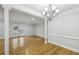 Open-concept living area with hardwood floors and french doors leading to the outside at 4430 Tilly Mill Rd # 1304, Atlanta, GA 30360