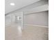 The spacious basement features tiled floors, natural light, and structural columns for a functional living area at 294 Arnold Mill Rd, Woodstock, GA 30188