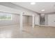 Finished basement featuring neutral tile flooring, support columns, and a staircase at 294 Arnold Mill Rd, Woodstock, GA 30188