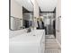Bathroom with a white vanity, black framed mirror, and glass shower stall with stone accent wall at 294 Arnold Mill Rd, Woodstock, GA 30188