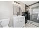 This bathroom boasts a white vanity, dark brick accent, and a modern glass-door shower for a modern aesthetic at 294 Arnold Mill Rd, Woodstock, GA 30188