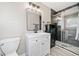 Modern bathroom features a glass shower stall, white vanity with black accents, and a gray floor mat at 294 Arnold Mill Rd, Woodstock, GA 30188