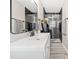 A well-lit bathroom boasts a sleek vanity, a modern shower with glass doors and dark brick accents at 294 Arnold Mill Rd, Woodstock, GA 30188