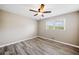 Bedroom with gray flooring featuring a window and a modern ceiling fan at 294 Arnold Mill Rd, Woodstock, GA 30188