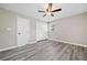 Bedroom with gray flooring features a window, a closet, and a modern ceiling fan at 294 Arnold Mill Rd, Woodstock, GA 30188