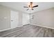 The bedroom showcases wood-look floors, double door closet, a ceiling fan, and natural light from the windows at 294 Arnold Mill Rd, Woodstock, GA 30188