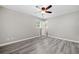 Bright bedroom features modern ceiling fan, new gray flooring, and a sunlit window at 294 Arnold Mill Rd, Woodstock, GA 30188