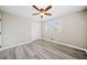 Bedroom with gray flooring featuring a window, closet, and modern ceiling fan at 294 Arnold Mill Rd, Woodstock, GA 30188
