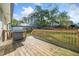 Wooden deck with a stainless steel grill overlooks the well-manicured yard at 294 Arnold Mill Rd, Woodstock, GA 30188
