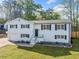 Stunning white brick home with black shutters, appealing landscaping, and a lush green lawn at 294 Arnold Mill Rd, Woodstock, GA 30188