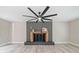 Inviting living room featuring hardwood floors, a modern fan, and a cozy fireplace at 294 Arnold Mill Rd, Woodstock, GA 30188