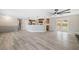Spacious open-concept living area with hardwood floors, modern fan, and views of the kitchen at 294 Arnold Mill Rd, Woodstock, GA 30188