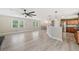 Spacious living area featuring wood floors and a clear view of the well-lit, modern kitchen at 294 Arnold Mill Rd, Woodstock, GA 30188