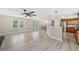 Spacious open-concept living area with hardwood floors, modern fan, and views of the kitchen at 294 Arnold Mill Rd, Woodstock, GA 30188