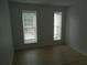 Bedroom with two windows offering light and a calming view, perfect for relaxation and rest at 3091 Colonial Way # B4, Atlanta, GA 30341