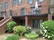 A brick townhouse with a balcony, lush greenery, and manicured landscaping at 3091 Colonial Way # B4, Atlanta, GA 30341