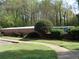 Landscaped front of house with brick wall and walkway providing an inviting approach at 3091 Colonial Way # B4, Atlanta, GA 30341
