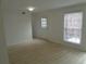 Bright living area featuring modern flooring, white walls and natural light from door and window at 3091 Colonial Way # B4, Atlanta, GA 30341