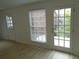 Inviting living room featuring modern flooring, bright walls, windows, and patio door at 3091 Colonial Way # B4, Atlanta, GA 30341