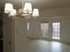 Bright living room with hardwood floors, light fixture, and access to the outside with glass doors at 3091 Colonial Way # B4, Atlanta, GA 30341