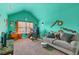 Bright bedroom space with vibrant teal walls, unique decor, and a comfortable seating area at 3169 Shadystone Way, Loganville, GA 30052