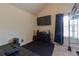 This bedroom with beige walls, a dark rug, and a large TV provides entertainment and relaxation at 3169 Shadystone Way, Loganville, GA 30052