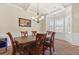 Elegant dining room with coffered ceilings, a chandelier, and bright windows at 3169 Shadystone Way, Loganville, GA 30052