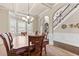 Elegant dining room featuring a decorative chandelier, large windows, and wainscoting at 3169 Shadystone Way, Loganville, GA 30052