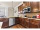 This kitchen features stainless appliances, granite countertops, and ample counter space at 3169 Shadystone Way, Loganville, GA 30052